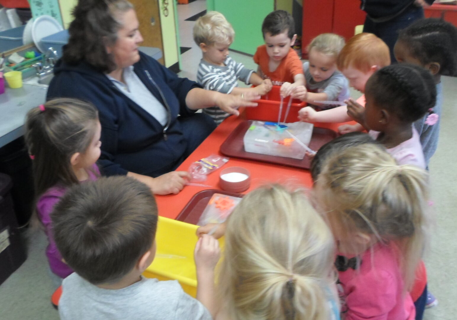 A group of children sitting around a table.